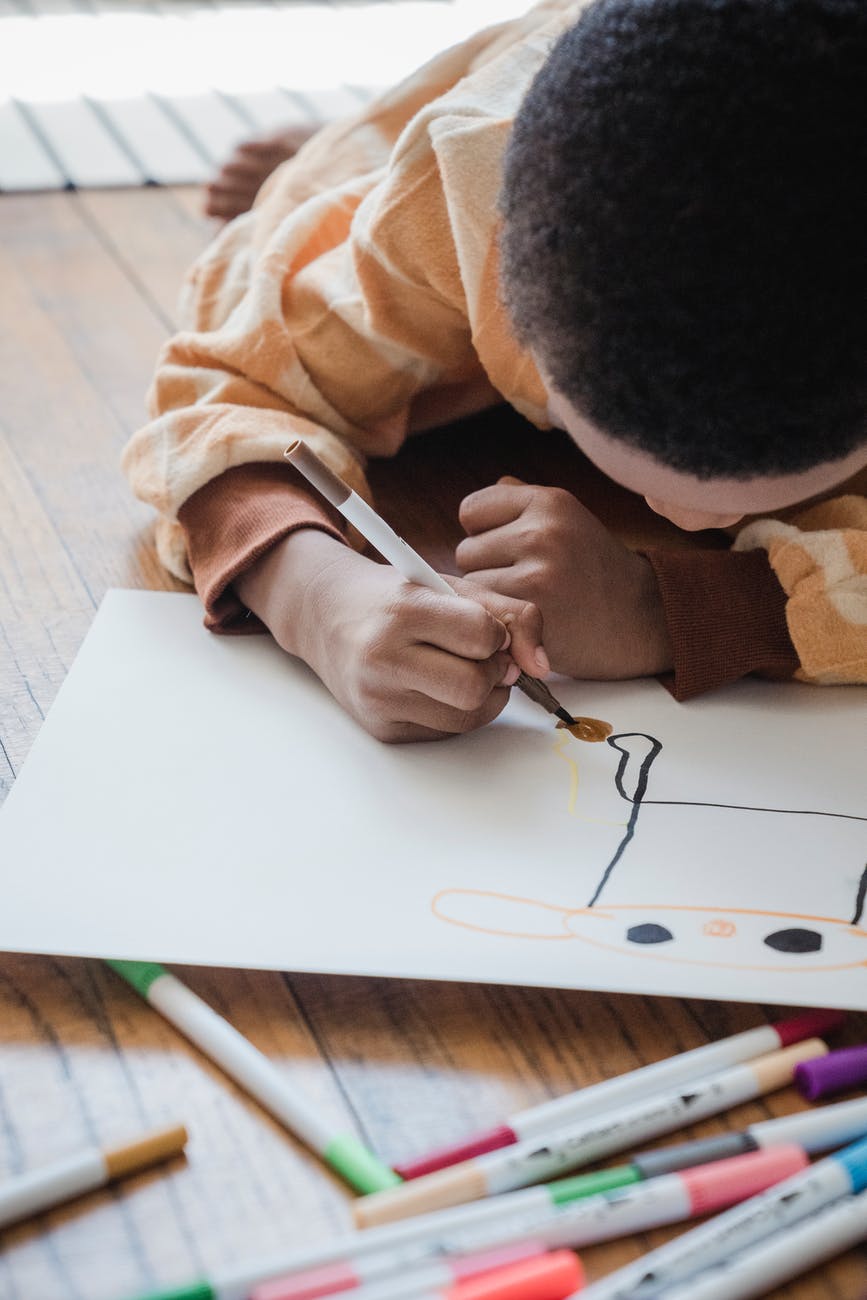 person drawing on white paper